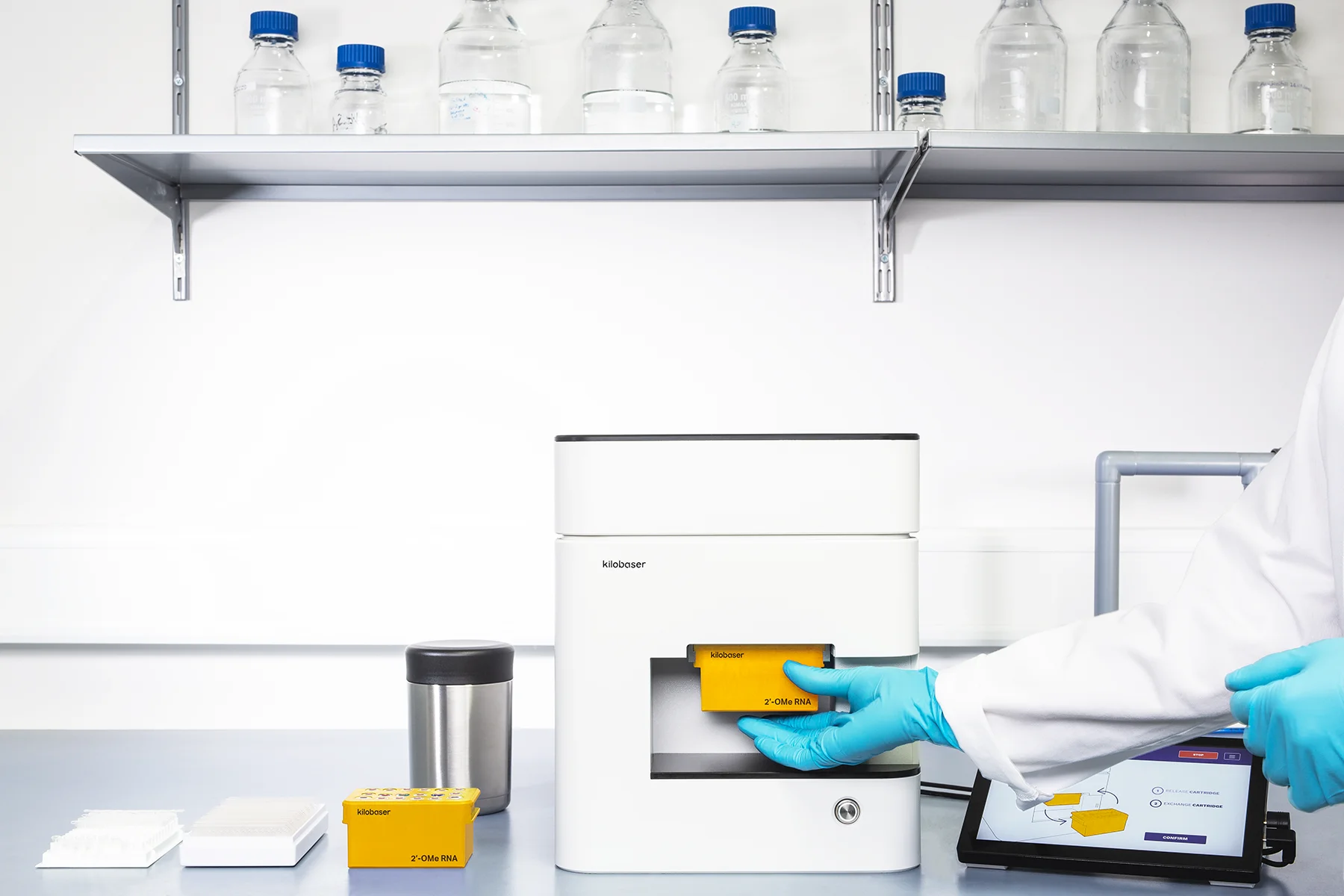 Images/Products/2’-OMe-RNA_kilobaser-exchange-cartridge Exchanging 2’-OMe RNA reagent cartridge for Kilobaser one-XT personal DNA & RNA synthesizer.